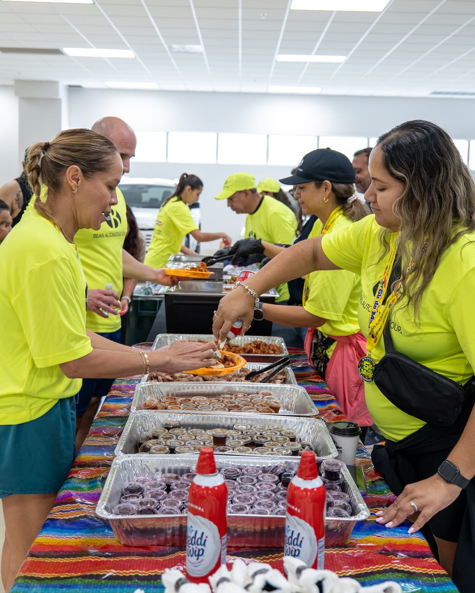 Leaders serving food at Bean Auto 5K de Mayo